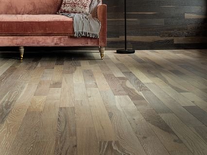 brown couch an a brown hardwood floor from Carpet Studio & Design Inc. in Los Angeles, CA