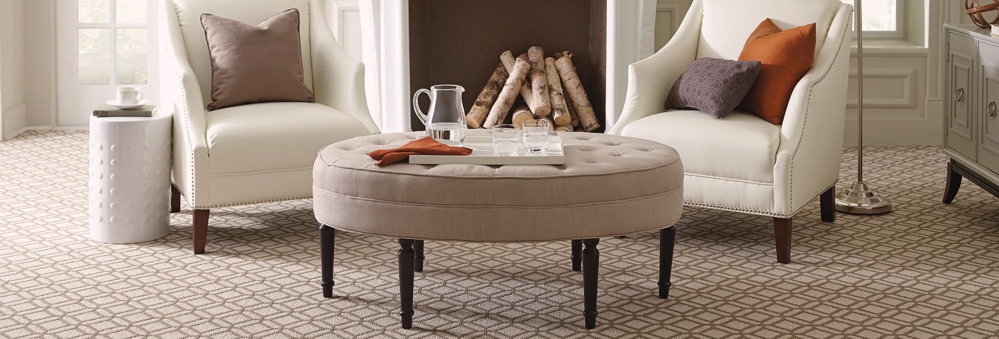 White armchair and brown coffee table in a living room with a brown carpet from Carpet Studio & Design Inc. in Los Angeles, CA