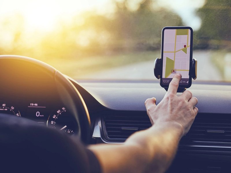 Person using GPS on phone while driving - Carpet Studio & Design Inc. in Los Angeles, CA