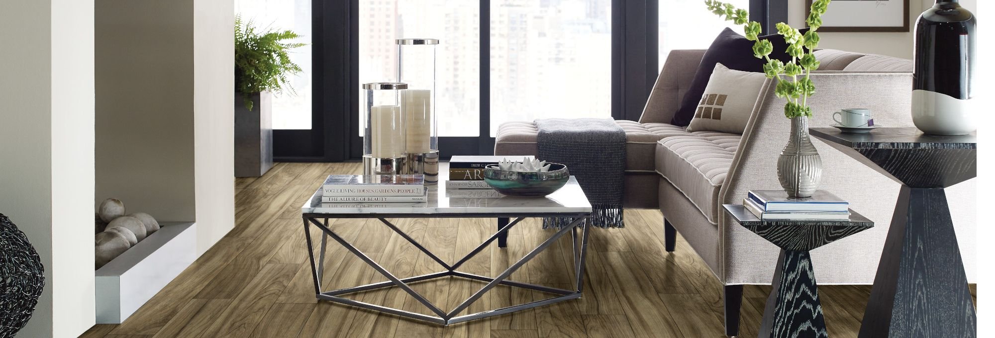 White couch and black coffee table on brown laminate floor from Carpet Studio & Design Inc. in Los Angeles, CA